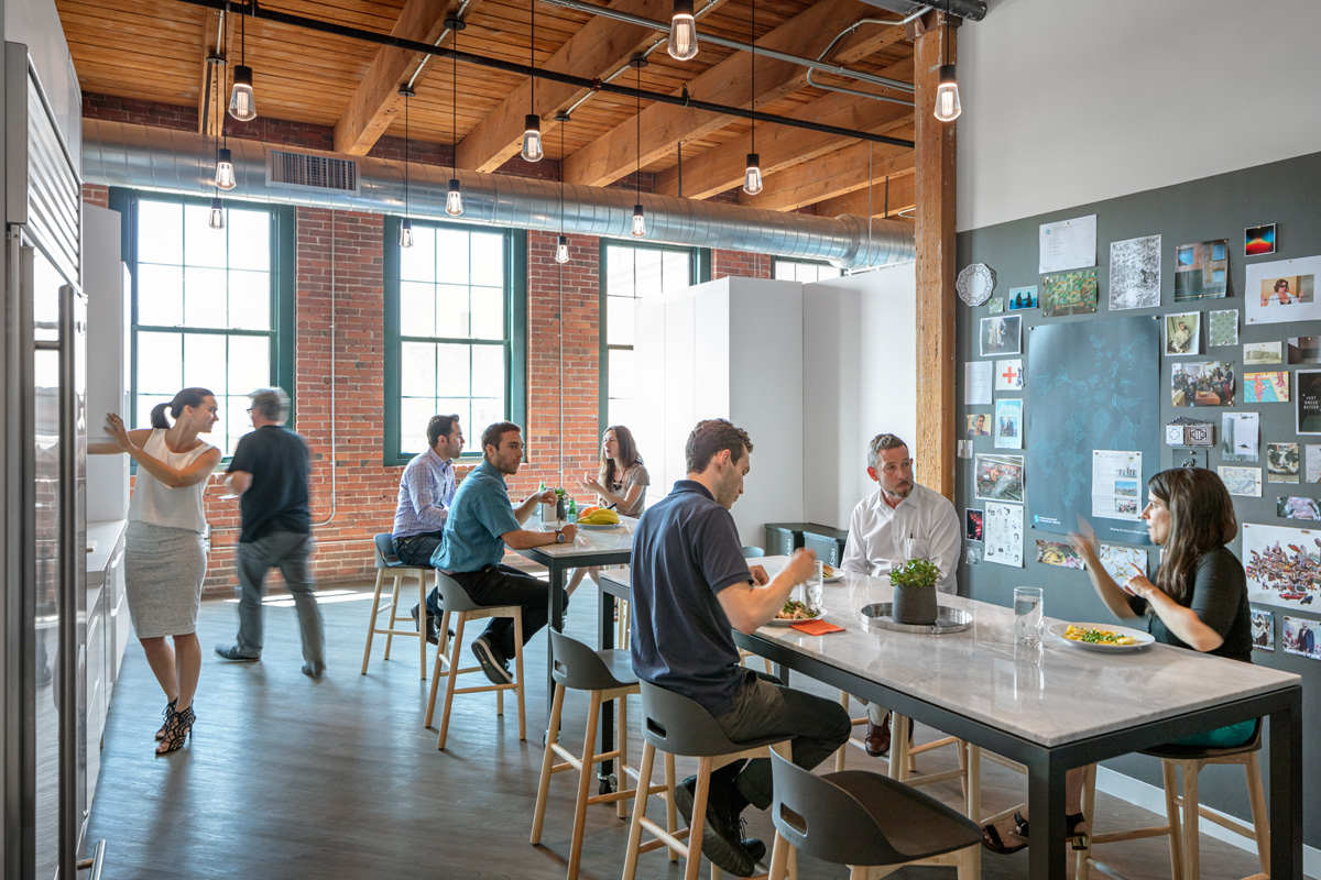 Hacin + Associates office kitchen with stone hightop tables