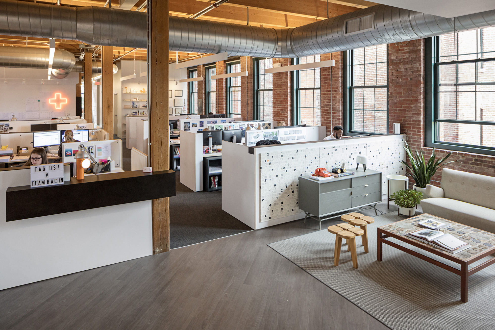 Hacin + Associates design office reception area with employees