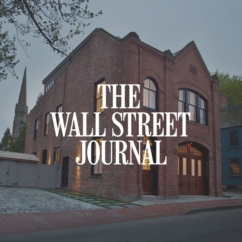 The Wall Street Times logo with brick building background