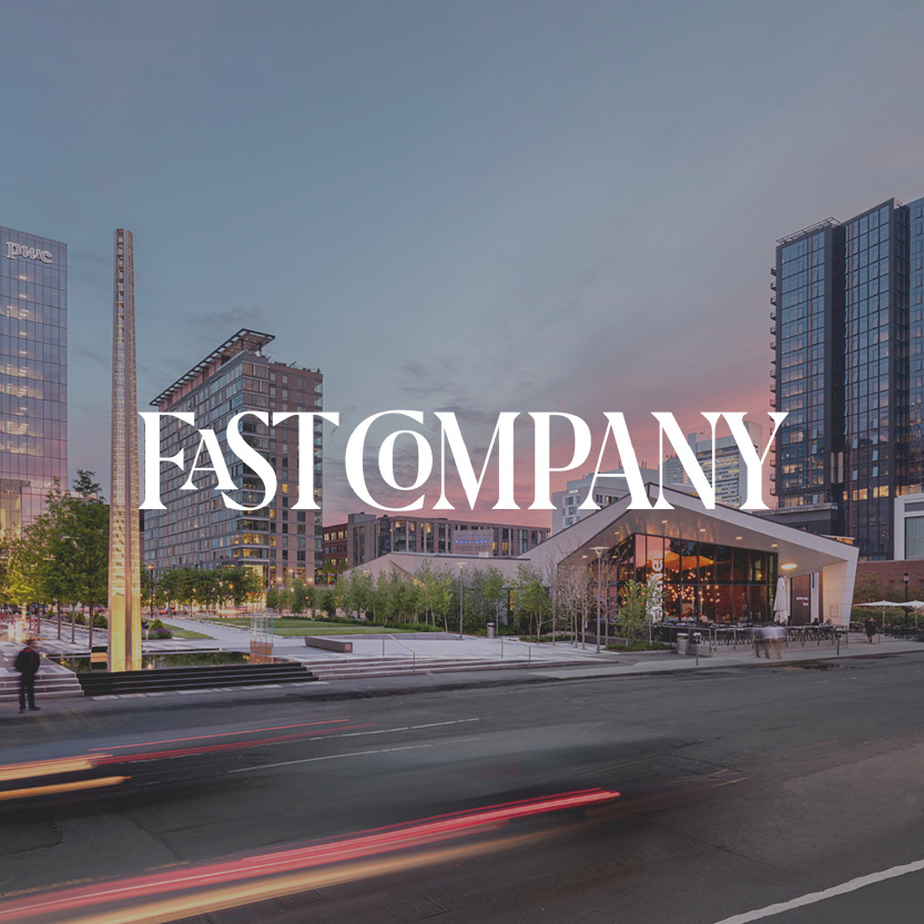 Fast Company logo with city street background