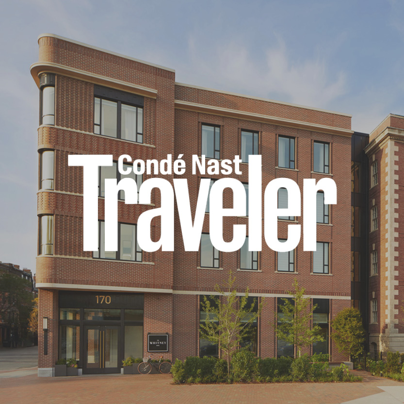 Condé Nast Traveler logo with brick commercial building background